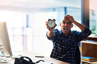 Buy stock photo Portrait of a young designer looking stressed out while holding an alarm clock