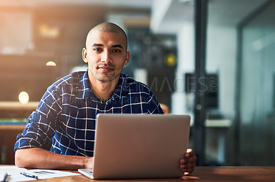 Buy stock photo Portrait of a young designer working on a laptop in an office