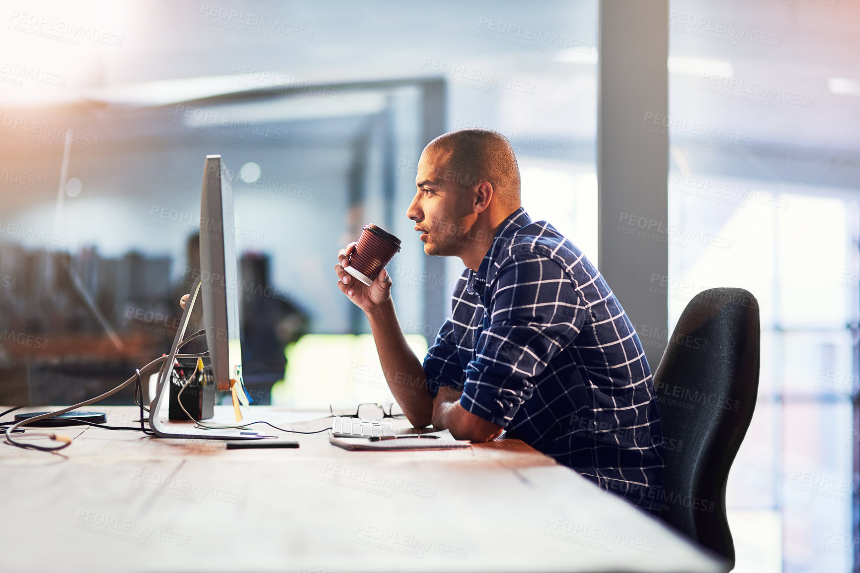 Buy stock photo Portrait of a young designer drinking coffee while working at his office desk