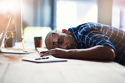 Buy stock photo Cropped shot of a young designer sleeping on his office desk