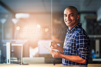 Buy stock photo Portrait of a young designer working on a digital tablet in an office