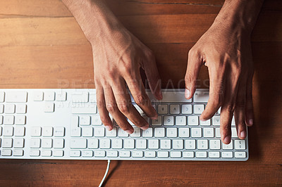 Buy stock photo High angle shot of an unidentifiable man typing on a keyboard at a desk