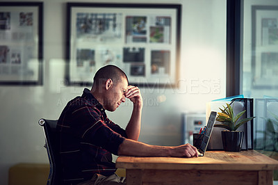 Buy stock photo Shot of a tired and stressed businessman working on his laptop while closing his eyes and contemplating