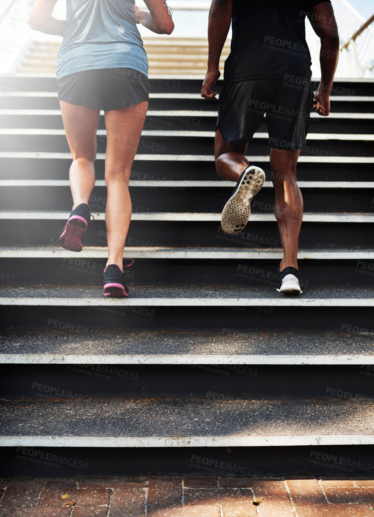 Buy stock photo Fitness, people and legs with running on stairs outdoor for marathon training, cardio exercise and teamwork. Back, athlete and runner with morning jog on steps for competition workout and endurance