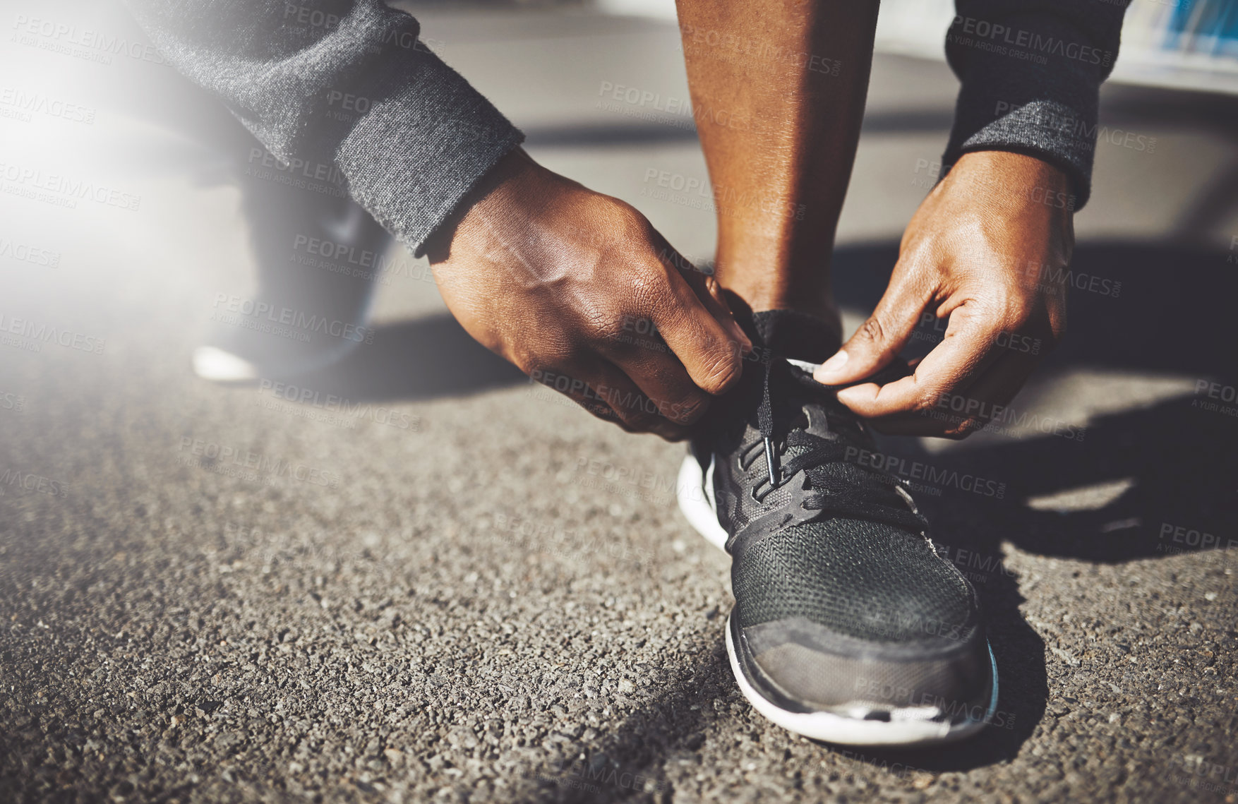 Buy stock photo Hands, runner or tie shoes in city for cardio training, running exercise or fitness workout in footwear. Closeup, man or male African athlete on ground ready to start jog, race or marathon practice