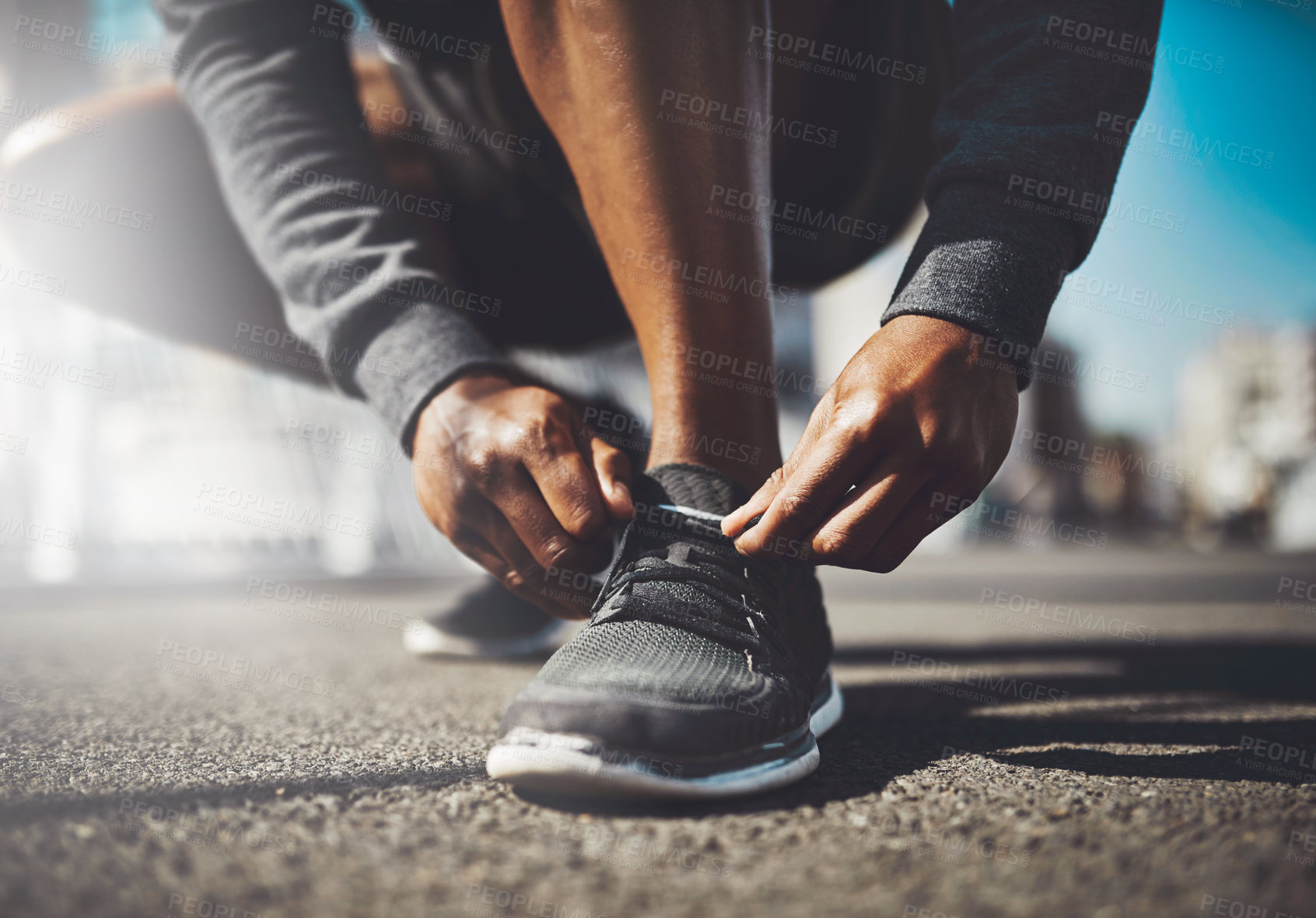 Buy stock photo Hands, runner or tie shoes in street for cardio training, running exercise and fitness workout in footwear. City, man and African athlete on ground ready to start jog, race or marathon in closeup