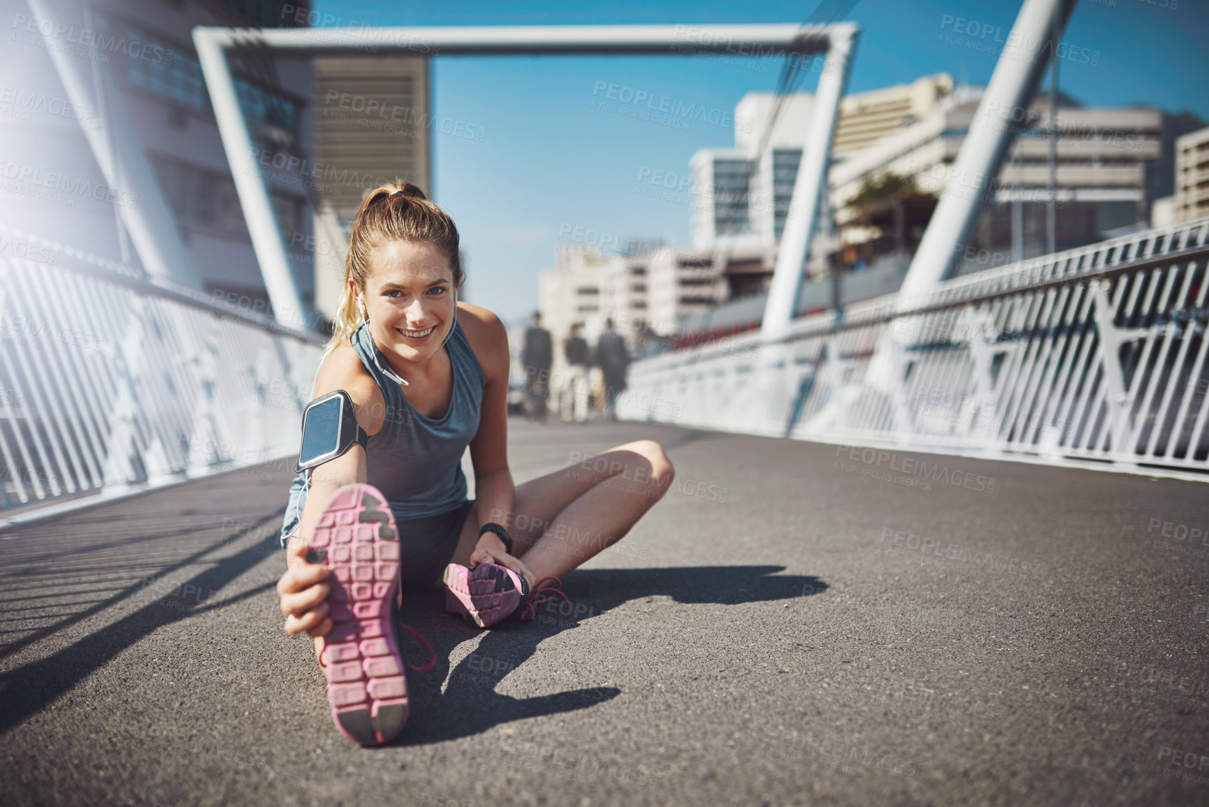 Buy stock photo Happy woman, portrait and stretching with bridge in city for exercise or workout preparation. Young, female person or active runner with smile on road, asphalt or street for warm up in an urban town