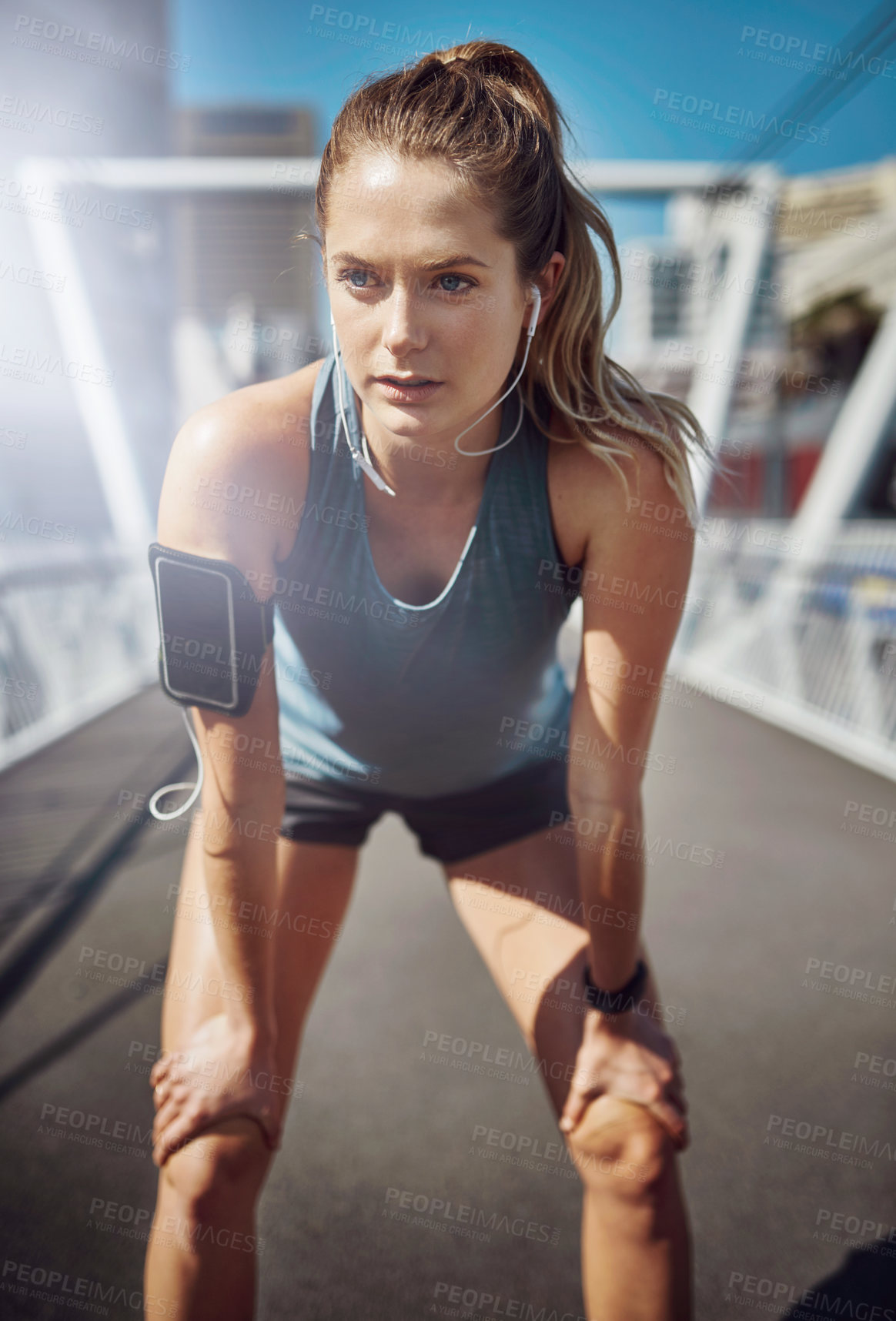 Buy stock photo Tired, woman thinking and runner in city with earphones for morning jog, exercise and outdoor workout. Athlete, training break and girl on bridge for running challenge, fitness and music playlist