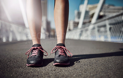 Buy stock photo Legs-only shot of a sporty woman standing on a bridge
