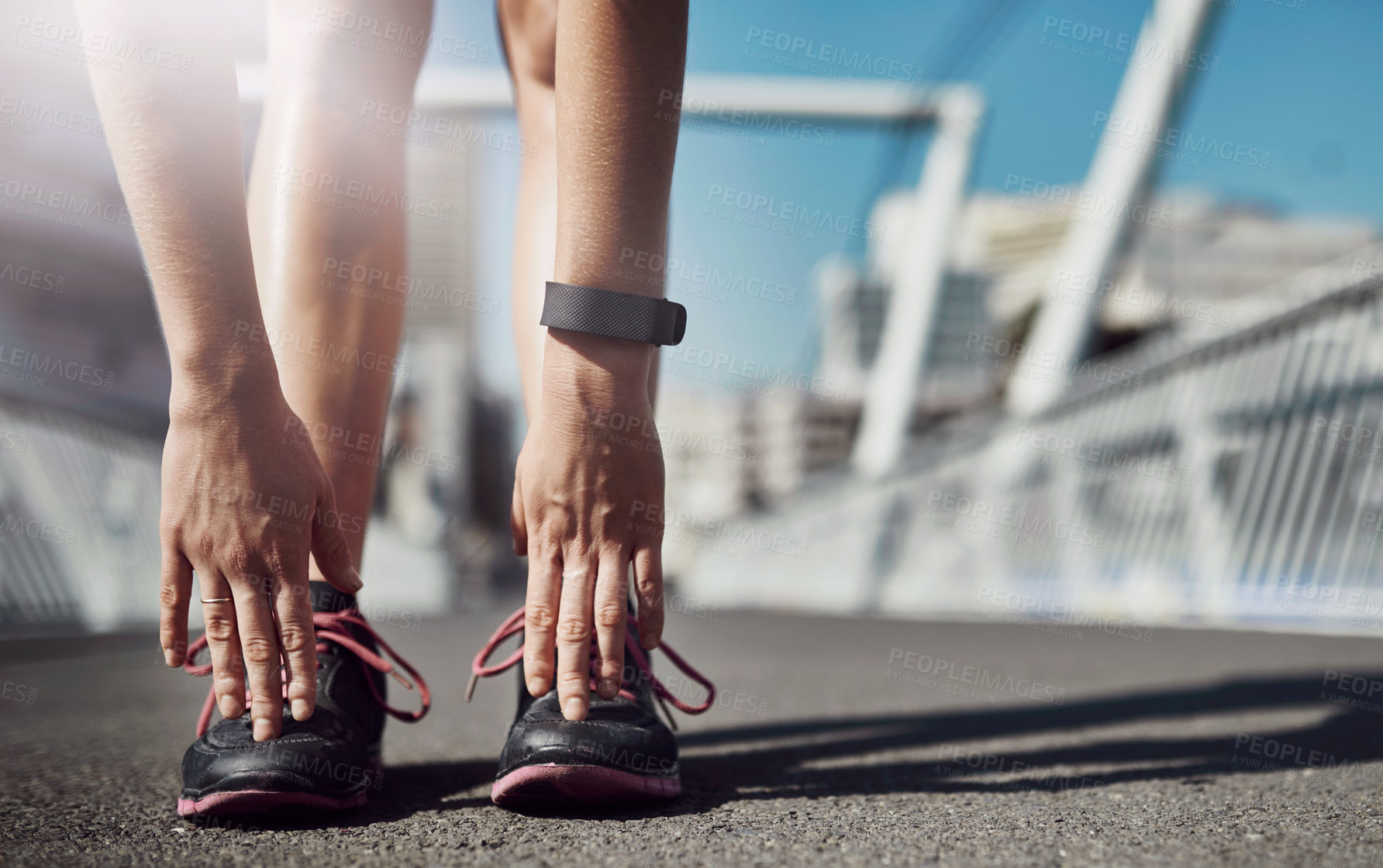 Buy stock photo Person, fitness and stretching feet with hands in city for exercise or workout preparation on bridge. Closeup, athlete or active runner with shoes on asphalt for warm up or balance in an urban town