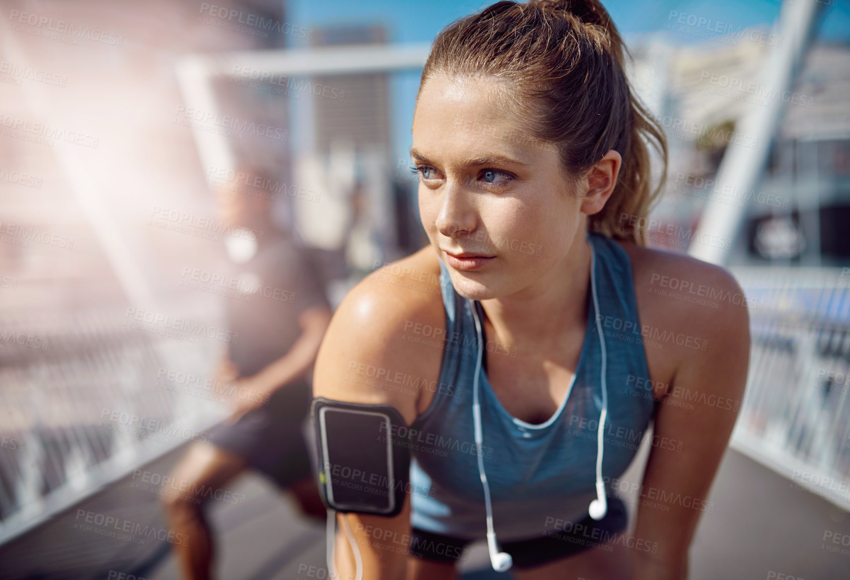 Buy stock photo Shot of two sporty young people standing on a bridge during their workout