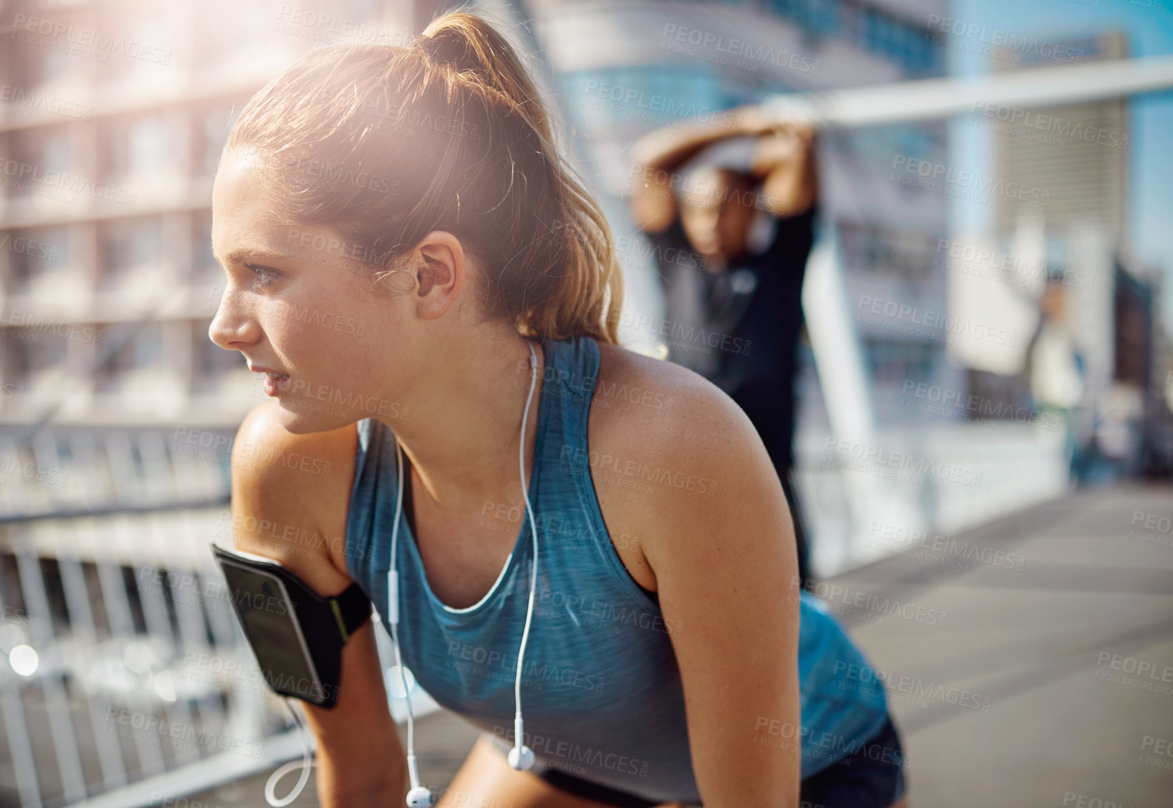 Buy stock photo Fitness, woman and tired in city for break, catching breath and training with partner. Girl, fatigue and rest on bridge with intense challenge, healthy body and outdoor for thinking with commitment