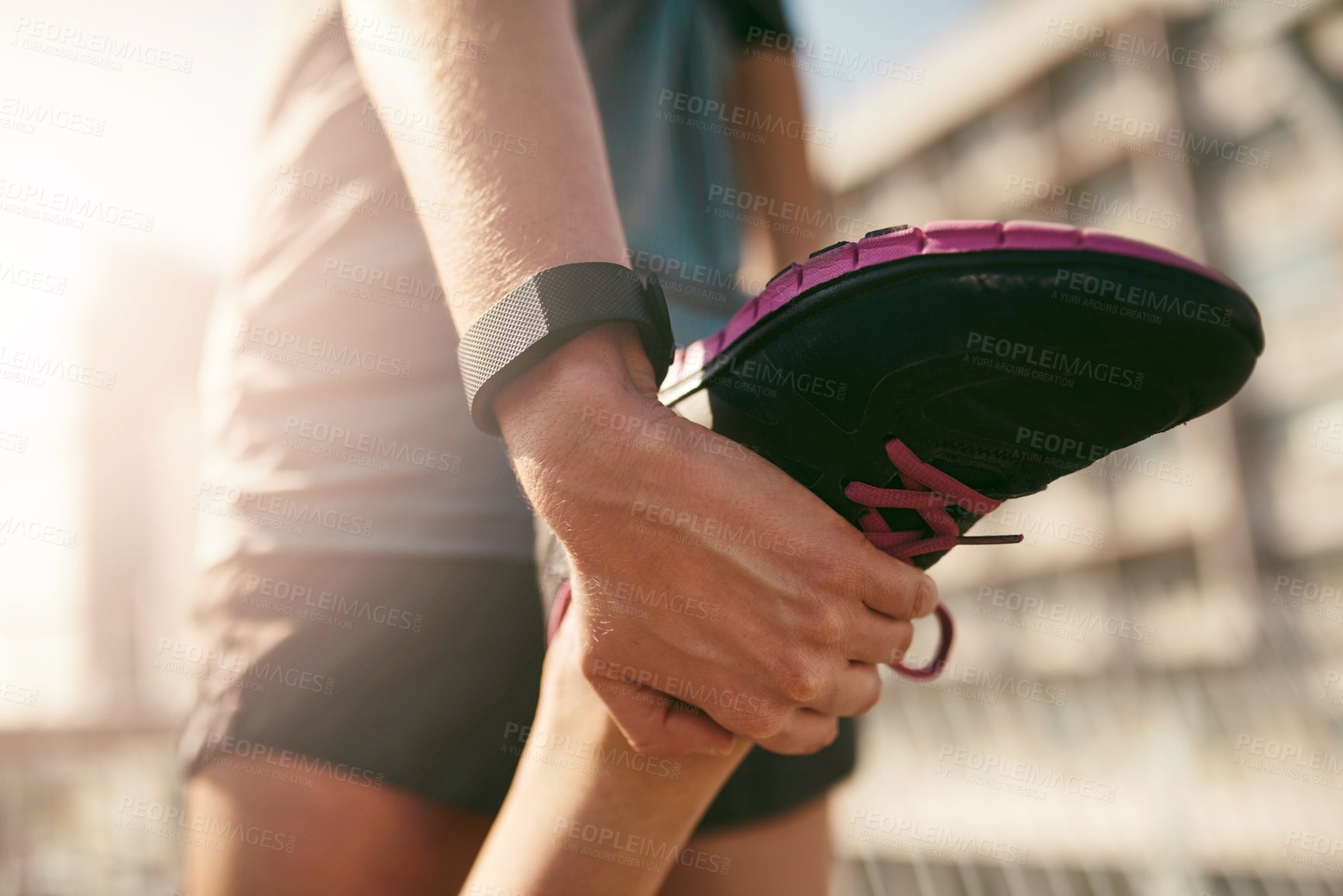 Buy stock photo Rearview shot of a sporty young woman stretching before a run