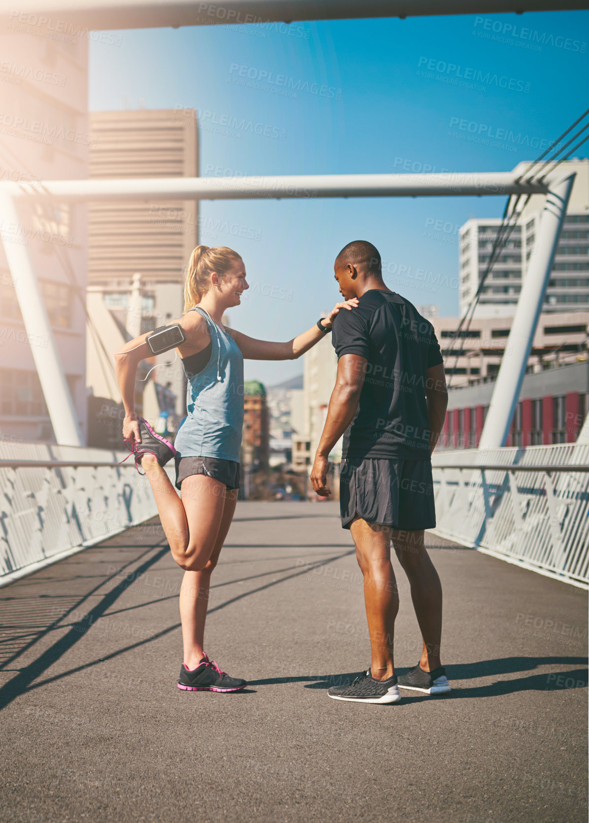 Buy stock photo Woman, man and stretching legs in city with warm up for muscle, health and start training on bridge. People, partnership and ready in profile for exercise, fitness and workout for wellness in morning