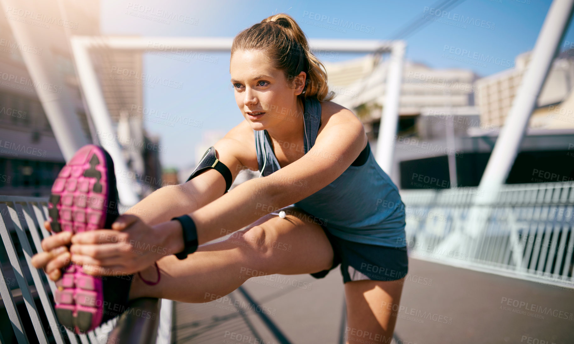 Buy stock photo Girl, stretching legs and bridge in city, morning and warm up with fitness, health and reflection in sunshine. Runner, woman and person with workout, muscle and ready to start exercise in Germany
