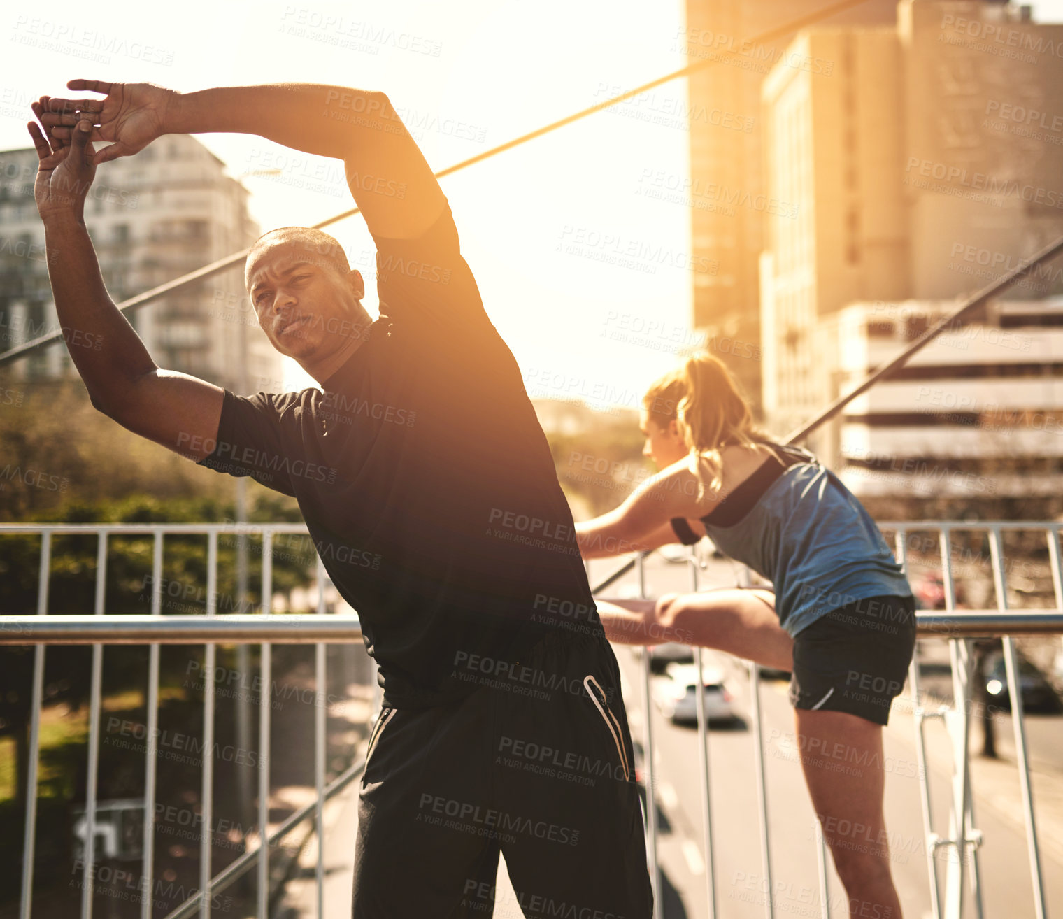 Buy stock photo Man, woman and stretching at sunset in city for muscle, health and start training on metro bridge. People, partnership and together with warm up for exercise, fitness or workout for wellness in town