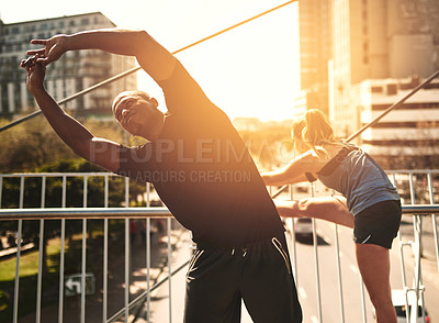 Buy stock photo Runner, man and woman with warm up in city for muscle, health and start training on metro bridge. People, partnership and stretching together for exercise, fitness and workout for wellness at sunset