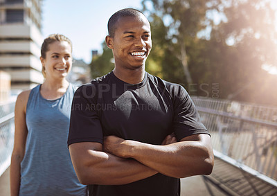 Buy stock photo Shot of two sporty young people standing outdoors