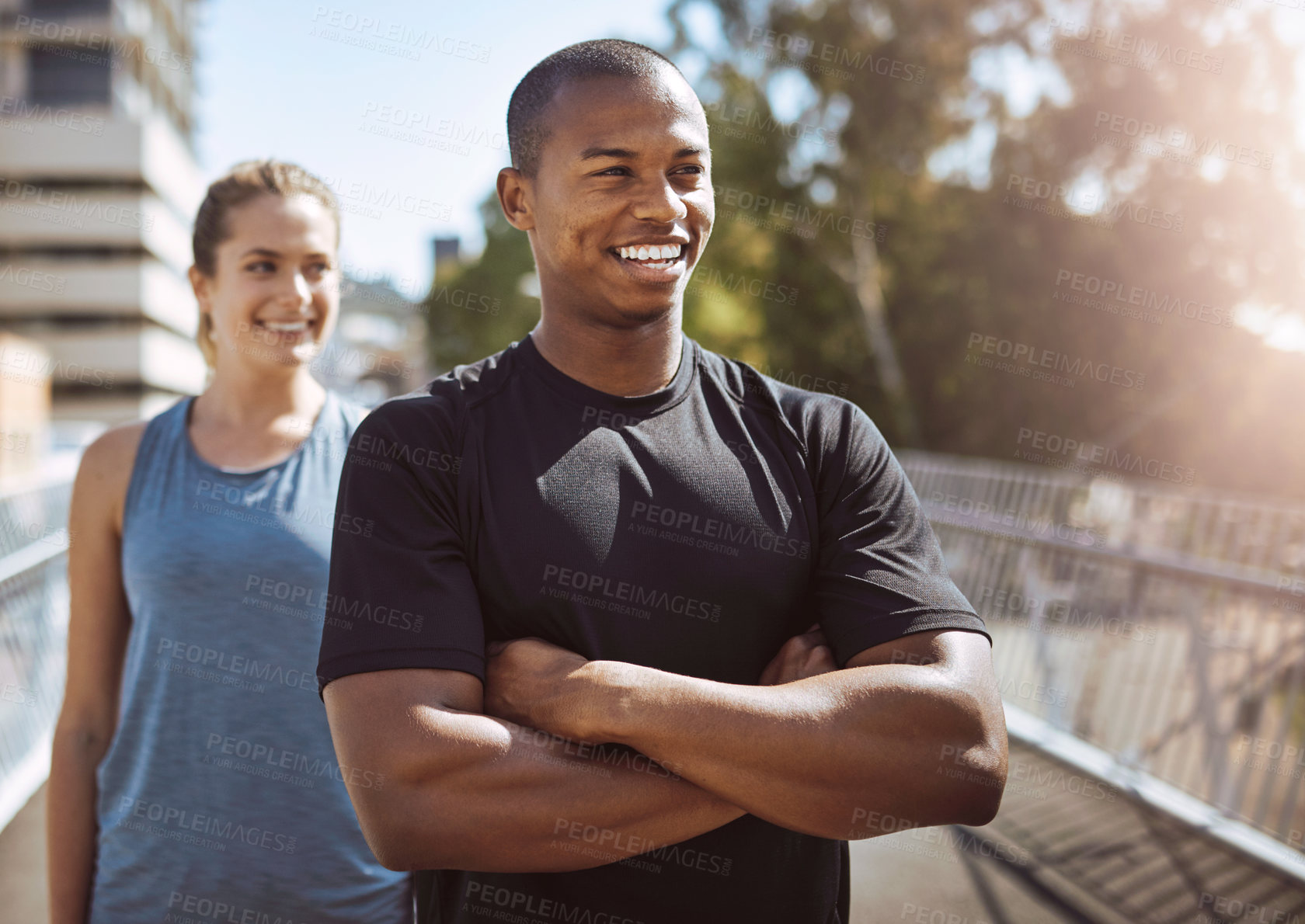 Buy stock photo Runner, man and woman in city with arms crossed or happy with reflection for workout on bridge in morning. Fitness coach, client and smile for training, exercise or excited for progress in metro town