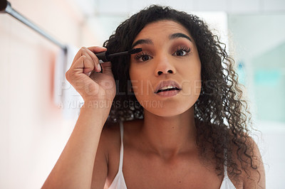 Buy stock photo Portrait of an attractive young woman applying mascara in the bathroom