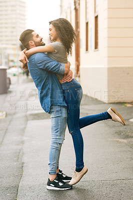 Buy stock photo Shot of a loving couple out in the city