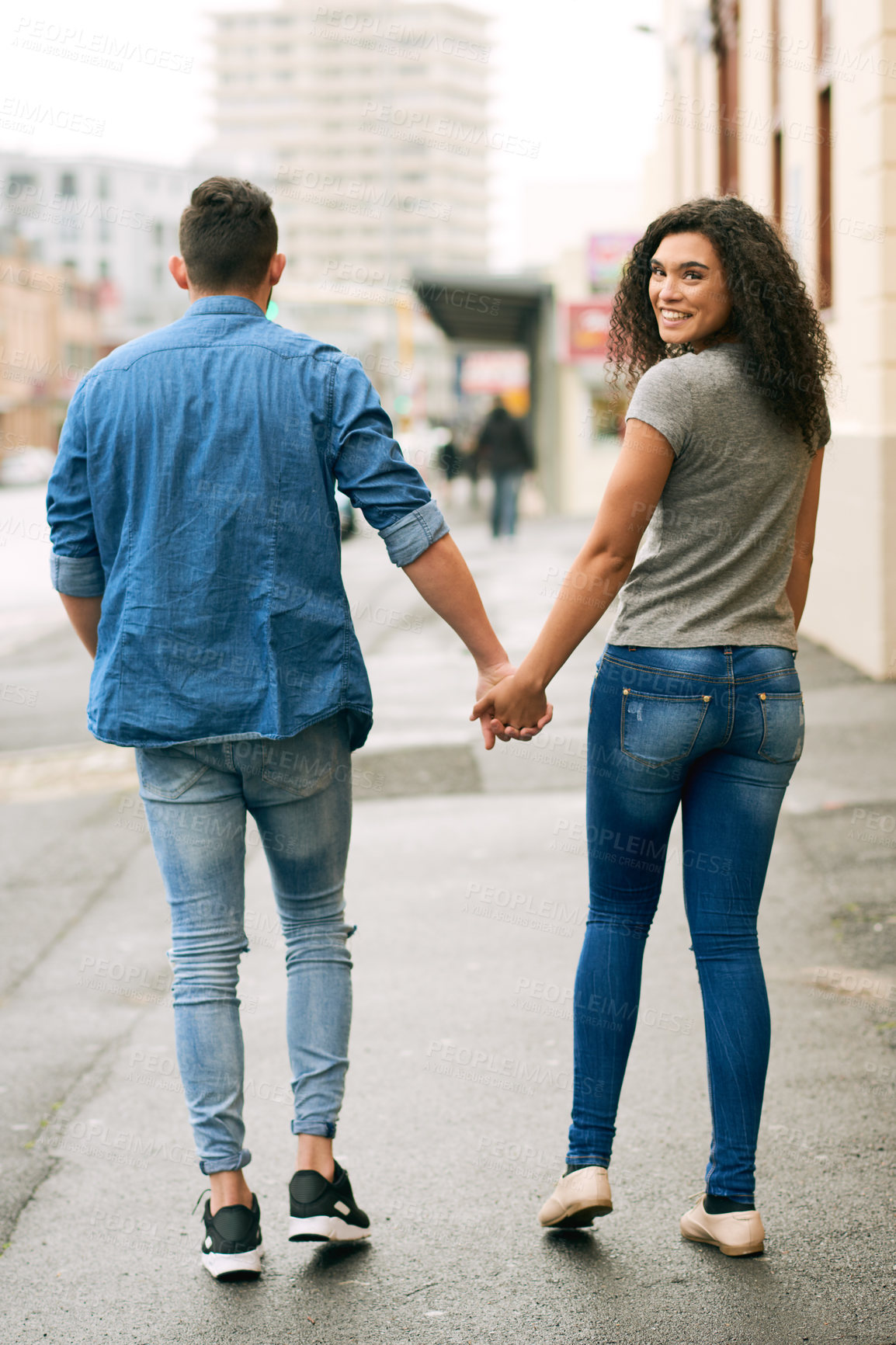 Buy stock photo City, couple and holding hands in portrait for walking, bonding and connection outdoor in street. Back of people, man and woman in relationship, commitment and romance in Spain for summer vacation