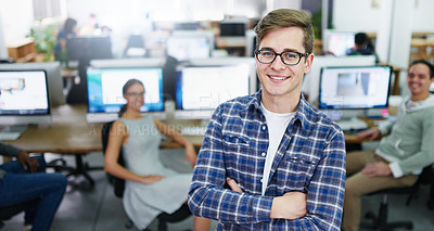 Buy stock photo Portrait of a smiling young designer standing in an office with colleagues working in the background
