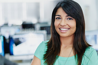 Buy stock photo Portrait of a smiling young designer standing in an office with computers in the background