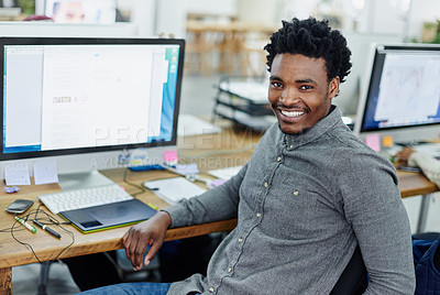 Buy stock photo Portrait of an smiling young designer sitting at a computer in an office