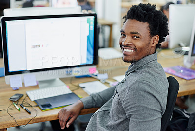 Buy stock photo Portrait of an smiling young designer sitting at a computer in an office