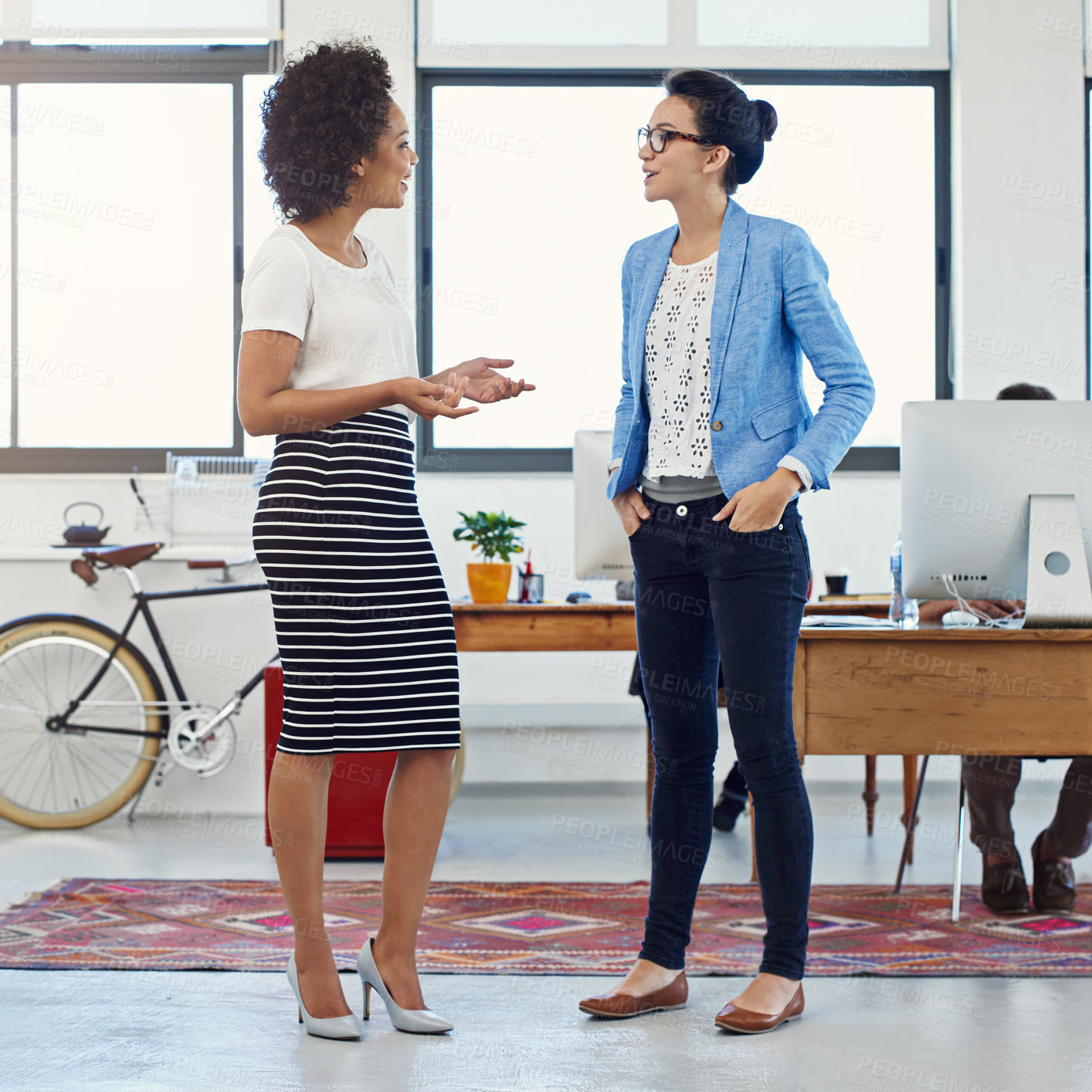 Buy stock photo Female people, colleague and conversation in office for brainstorming, project or coworking space at job. Women, employee and discussion for communication, teamwork or collaboration in digital agency