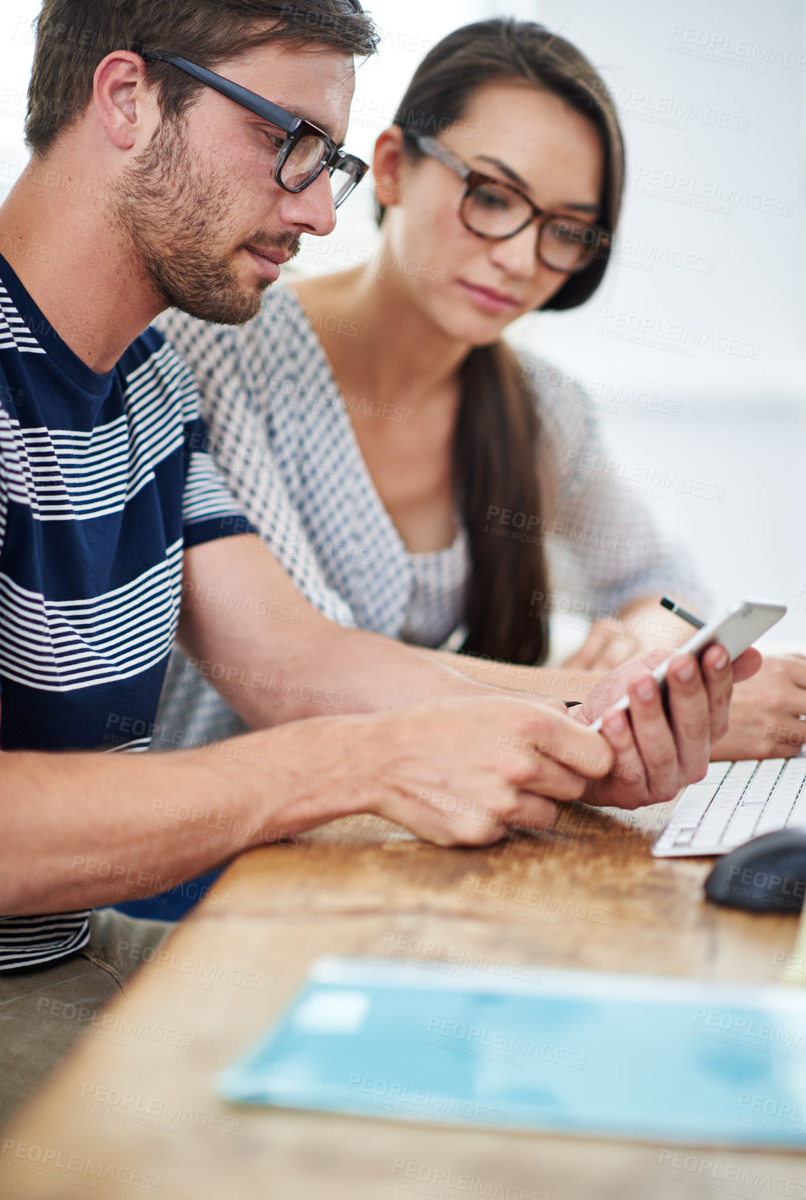 Buy stock photo Man, woman and together with phone in office for creative, notification for company update on social media. Business people, teamwork and technology or online network with announcement for design