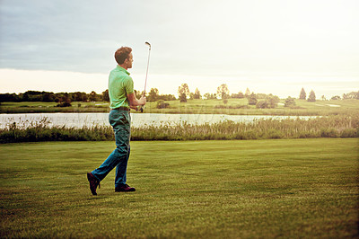 Buy stock photo Shot of a man practicing his swing on the golf course