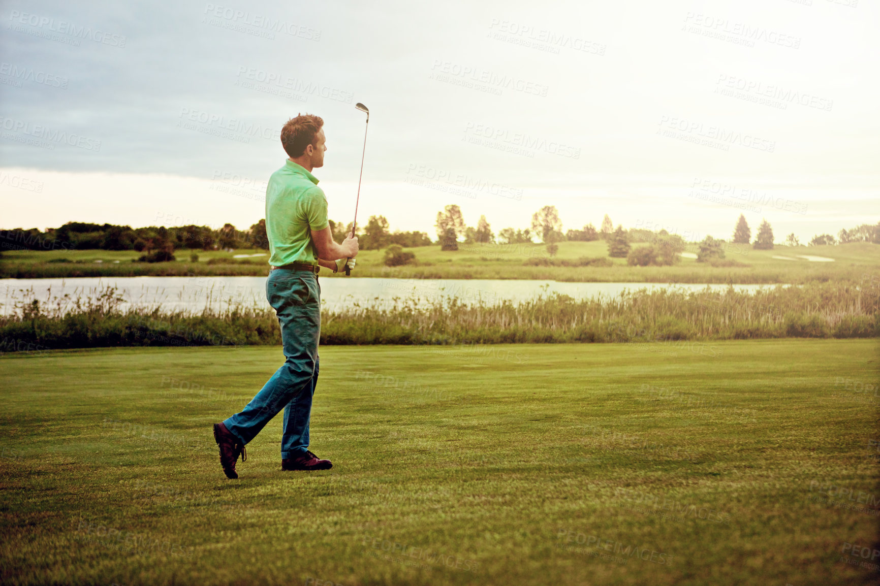 Buy stock photo Shot of a man practicing his swing on the golf course