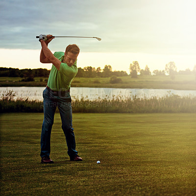 Buy stock photo Shot of a man practicing his swing on the golf course