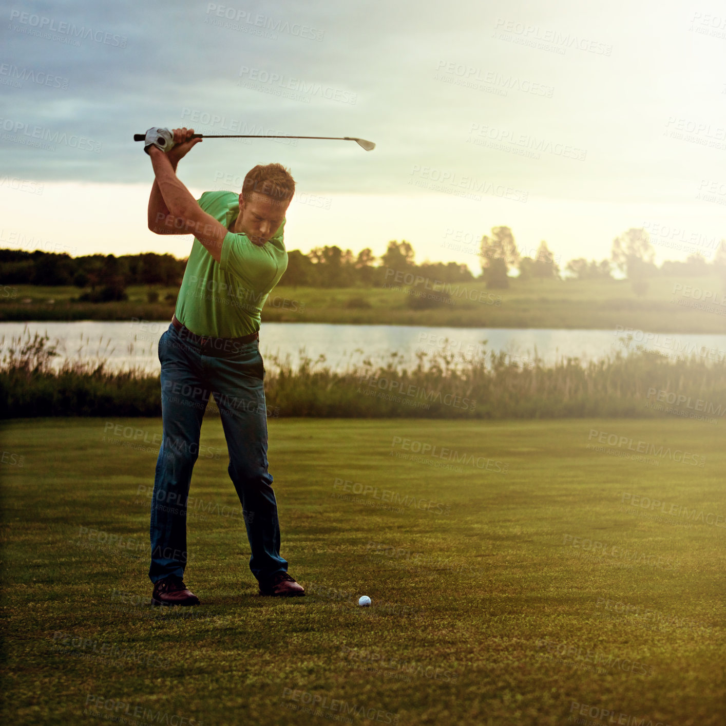 Buy stock photo Shot of a man practicing his swing on the golf course