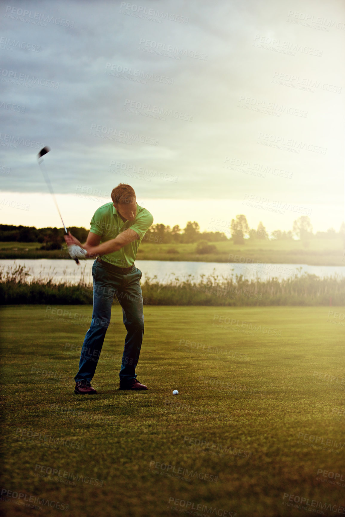 Buy stock photo Shot of a man practicing his swing on the golf course