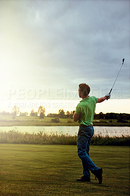 Buy stock photo Shot of a young man spending the day on a golf course