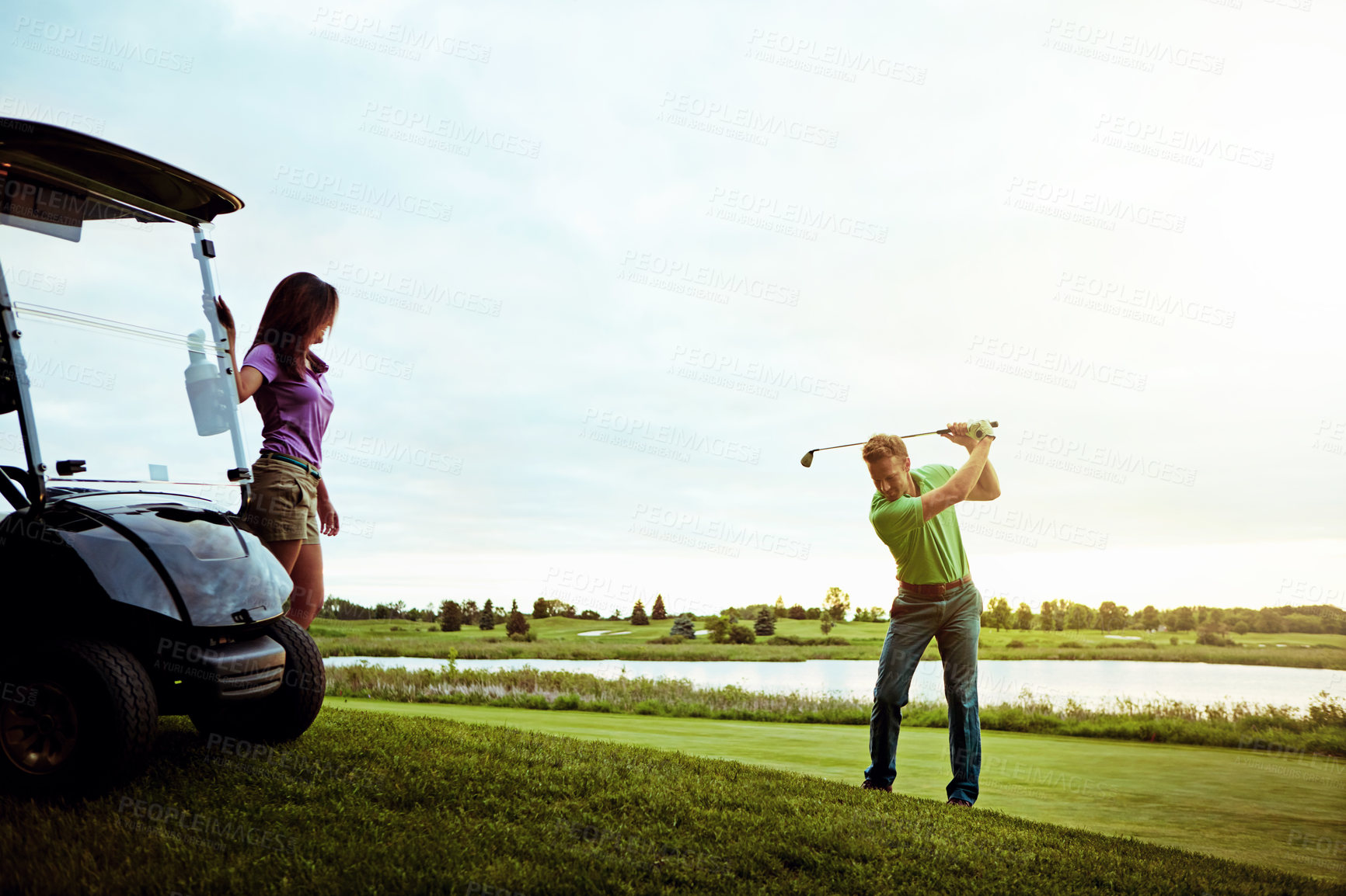 Buy stock photo Shot of a man practicing his swing on the golf course