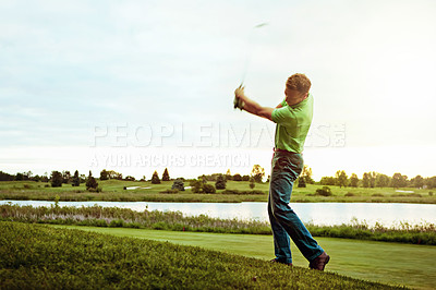 Buy stock photo Shot of a man practicing his swing on the golf course