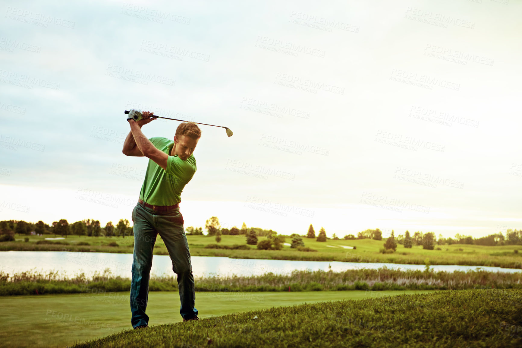 Buy stock photo Shot of a man practicing his swing on the golf course