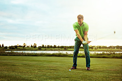 Buy stock photo Shot of a man practicing his swing on the golf course