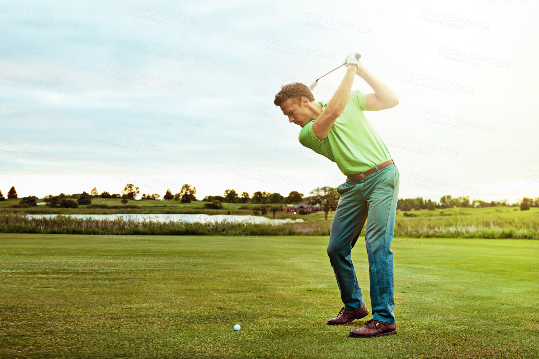 Buy stock photo Shot of a man practicing his swing on the golf course