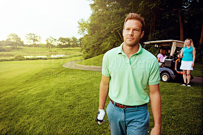 Buy stock photo Shot of a man playing a round of golf with his friends