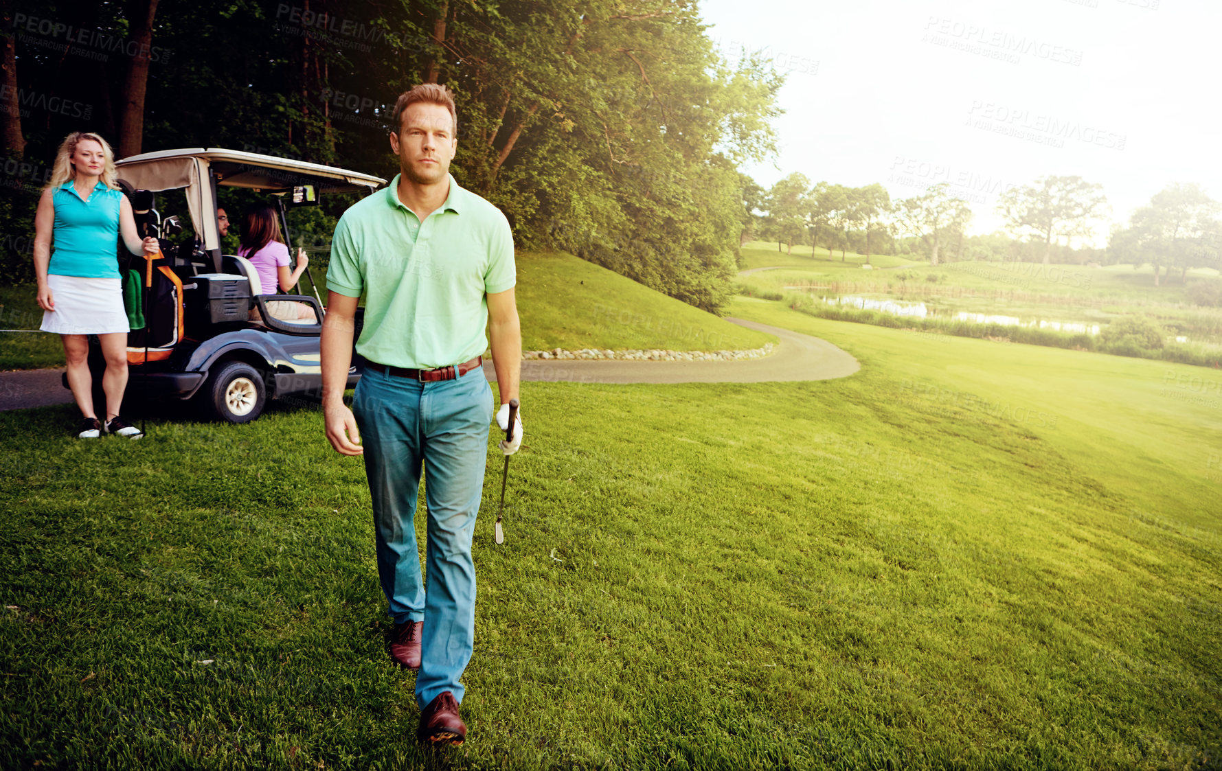 Buy stock photo Shot of a man playing a round of golf with his friends