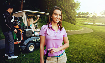 Buy stock photo Shot of a woman playing a round of golf with her friends