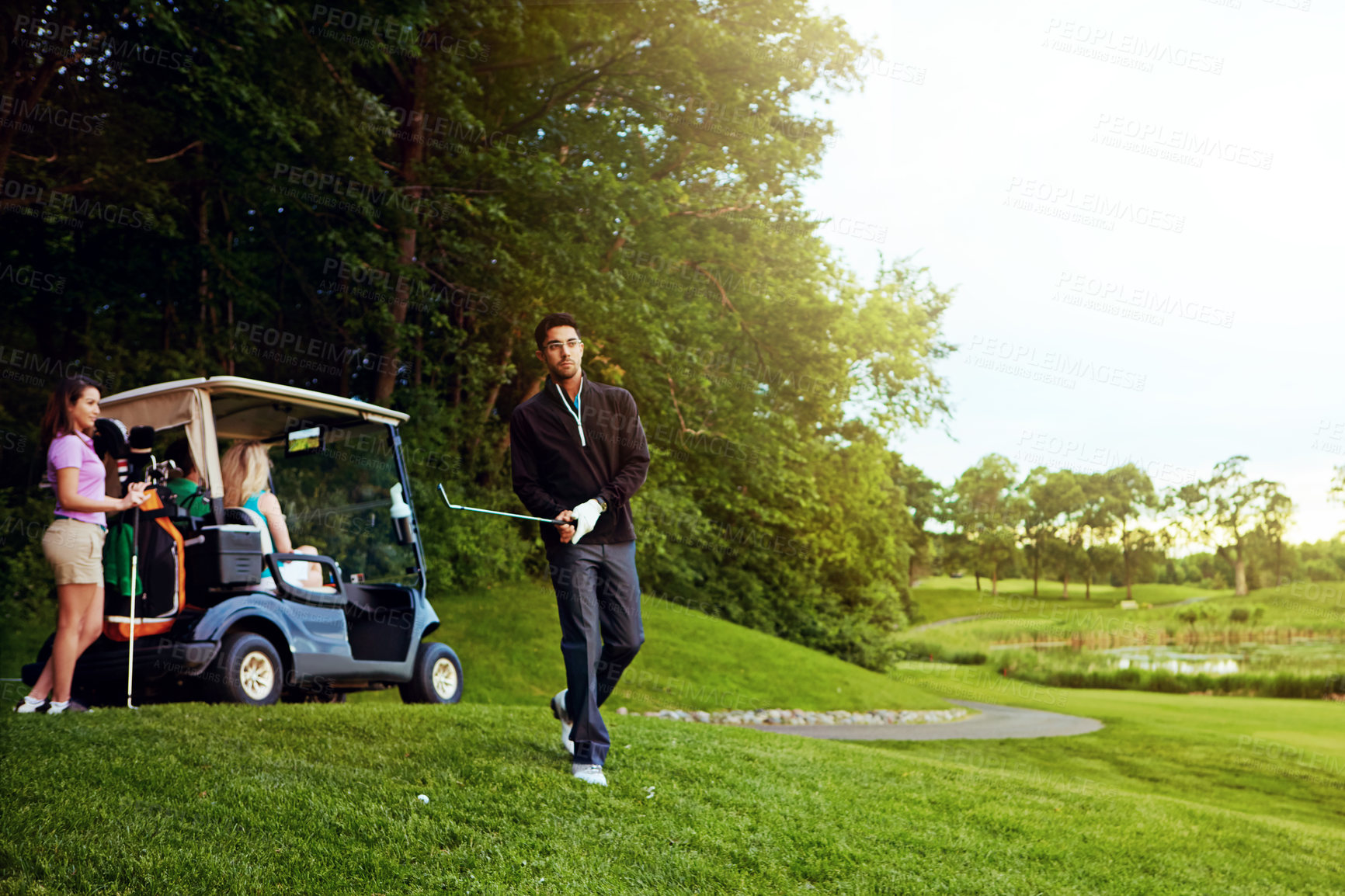 Buy stock photo Shot of a man playing a round of golf with his friends