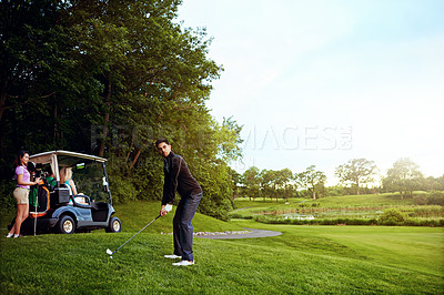 Buy stock photo Shot of a man playing a round of golf with his friends