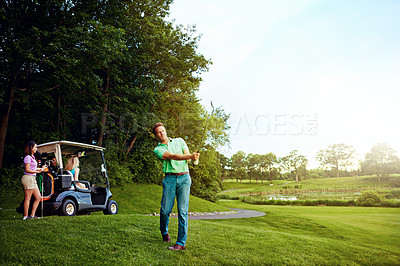 Buy stock photo Shot of a man playing a round of golf with his friends