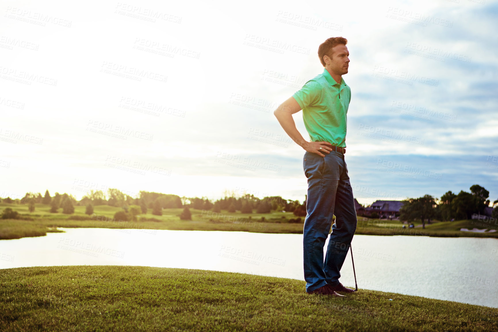 Buy stock photo Shot of a young man spending the day on a golf course